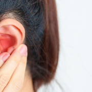 Woman holding her painful Ear. Ear disease, Atresia, Otitis Media, Inflation, Pertorated Eardrum, Meniere syndrome, otolaryngologist, Ageing Hearing Loss and Health concept dolor de oído persistente